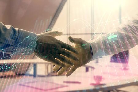Multi exposure of financial graph on office background with two businessmen handshake. Concept of success in businessの写真素材