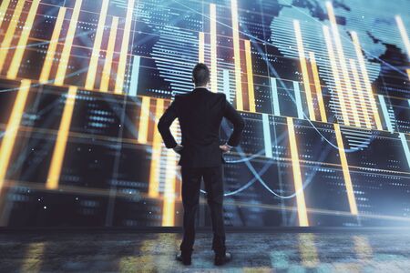 Businessman and forex graph and world map hologram. Double exposure. Concept of financial education and analysisの写真素材