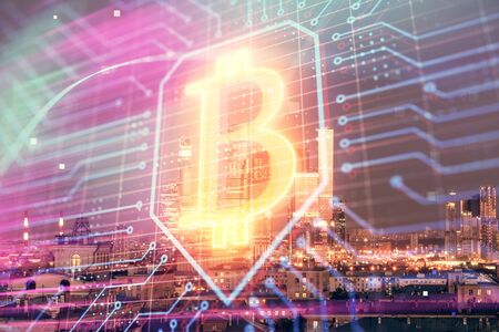 Double exposure of bitcoin sign drawing hologram on cityscape background. Concept of crypto economy