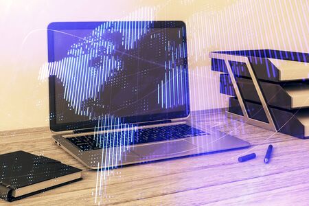 Map hologram and desktop office computer background. Multi exposure. Concept of international businessの写真素材