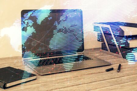 Map hologram and desktop office computer background. Multi exposure. Concept of international businessの写真素材
