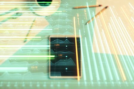 Double exposure of forex graph on digital tablet laying on table background. Concept of market...
