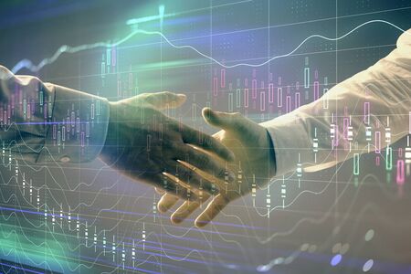 Multi exposure of forex graph on abstract background with two businessmen handshake. Concept of...