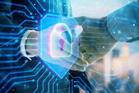 Double exposure of lock icon hologram on city view background with two people handshake. Concept of...
