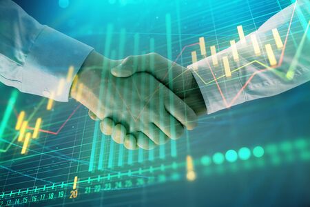 Multi exposure of forex graph on abstract background with two businessmen handshake. Concept of...