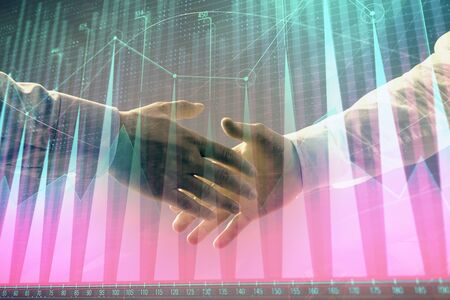Multi exposure of forex graph on abstract background with two businessmen handshake. Concept of...