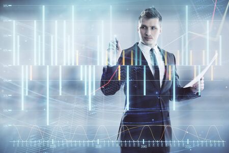 Businessman and forex graph hologram. Double exposure. Concept of financial education and analysisの写真素材
