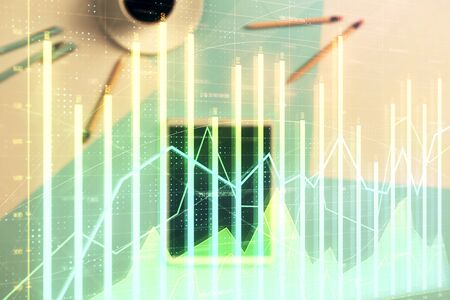 Double exposure of forex graph on digital tablet laying on table background. Concept of market analysisの写真素材