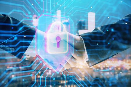 Double exposure of lock icon hologram on city view background with two people handshake. Concept of...
