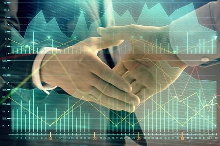 Multi exposure of forex graph on abstract background with two businessmen handshake. Concept of success on stock marketの写真素材
