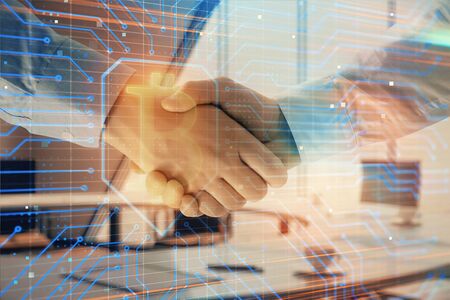 Double exposure of blockchain theme drawing on office background with two businessmen handshake. Concept of crypto economyの写真素材