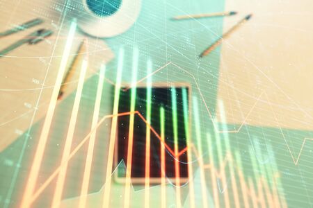 Double exposure of forex graph on digital tablet laying on table background. Concept of market analysisの写真素材