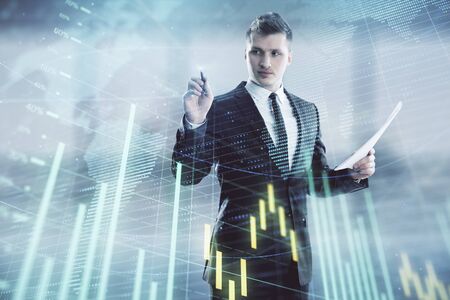 Businessman and forex graph and world map hologram. Double exposure. Concept of financial education and analysisの写真素材