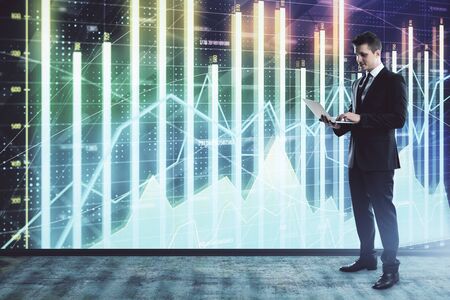 Businessman and forex graph hologram. Double exposure. Concept of financial education and analysisの写真素材