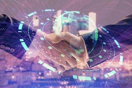 Double exposure of world map on cityscape background with two businessmen handshake. Concept of international businessの写真素材