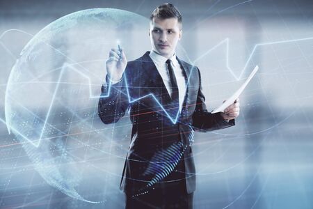 Businessman and forex graph and world map hologram. Double exposure. Concept of financial education and analysisの写真素材