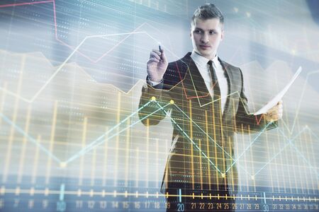 Businessman and forex graph hologram. Double exposure. Concept of financial education and analysisの写真素材