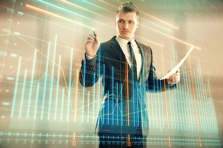 Businessman and forex graph hologram. Double exposure. Concept of financial education and analysisの写真素材