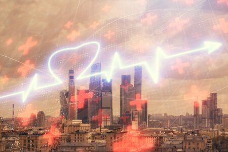 Multi exposure of human heart hologram on Moscow cityscape background. Concept of medical educationの写真素材