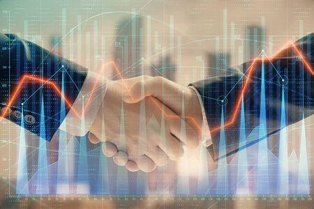 Double exposure of financial graph on cityscape background with two businessman handshake. Concept of stock market dealの写真素材
