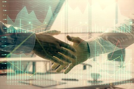 Multi exposure of financial graph on office background with two businessmen handshake. Concept of success in businessの写真素材