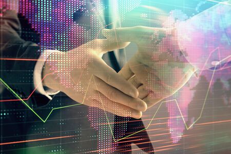 Multi exposure of forex graph and world map on abstract background with two businessmen handshake. Concept of success on international marketsの写真素材
