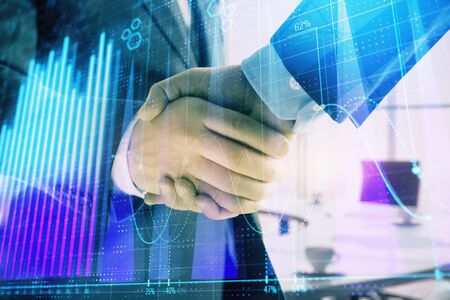 Multi exposure of financial graph on office background with two businessmen handshake. Concept of success in businessの写真素材