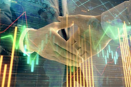 Multi exposure of forex graph and world map on abstract background with two businessmen handshake. Concept of success on international marketsの写真素材