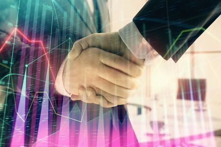 Multi exposure of financial graph on office background with two businessmen handshake. Concept of success in businessの写真素材