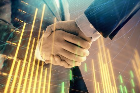 Multi exposure of forex graph on abstract background with two businessmen handshake. Concept of success on stock marketの写真素材