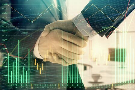 Multi exposure of financial graph on office background with two businessmen handshake. Concept of success in businessの写真素材