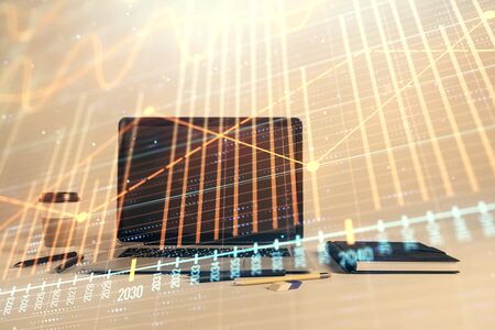 Forex graph hologram with desktop office computer background. Double exposure. Concept of financial analysis.の写真素材