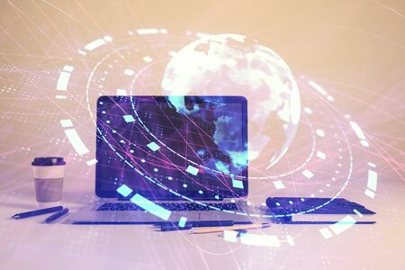 Map hologram and desktop office computer background. Multi exposure. Concept of international businessの写真素材