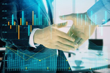 Multi exposure of financial graph on office background with two businessmen handshake. Concept of success in businessの写真素材