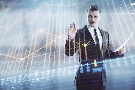 Businessman and forex graph hologram. Double exposure. Concept of financial education and analysisの写真素材