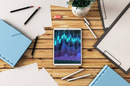 Digital tablet closeup top view with financial graph on screen. Online trading application concept. 3d rendering.の写真素材