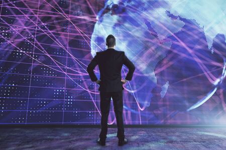 Businessman and world map hologram. Double exposure. Concept of international financeの写真素材