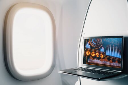 Laptop closeup inside airplane with business theme pic on screen. On air online business concept. 3d rendering.の写真素材