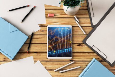 Digital tablet closeup top view with financial graph on screen. Online trading application concept. 3d rendering.の写真素材