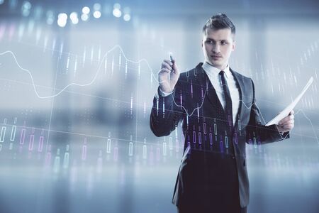 Businessman and forex graph hologram. Double exposure. Concept of financial education and analysisの写真素材
