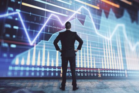 Businessman and forex graph hologram. Double exposure. Concept of financial education and analysisの写真素材