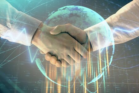 Multi exposure of forex graph and world map on abstract background with two businessmen handshake. Concept of success on international marketsの写真素材