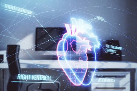Heart hologram with desktop office background. Double exposure. Concept of medical educationの写真素材