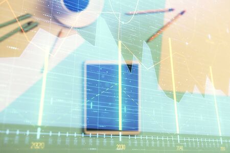 Double exposure of forex graph on digital tablet laying on table background. Concept of market analysisの写真素材