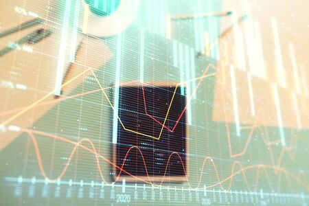 Double exposure of forex graph on digital tablet laying on table background. Concept of market analysisの写真素材