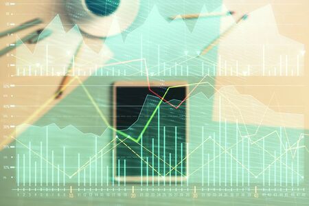 Double exposure of forex graph on digital tablet laying on table background. Concept of market analysisの写真素材