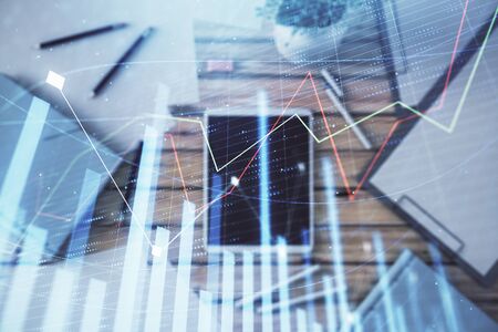Double exposure of forex graph on digital tablet laying on table background. Concept of market analysisの写真素材