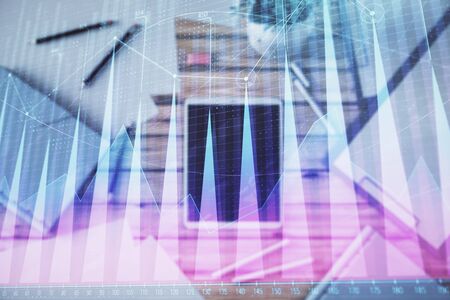 Double exposure of forex graph on digital tablet laying on table background. Concept of market analysisの写真素材
