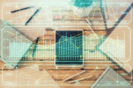 Double exposure of forex graph on digital tablet laying on table background. Concept of market analysisの写真素材