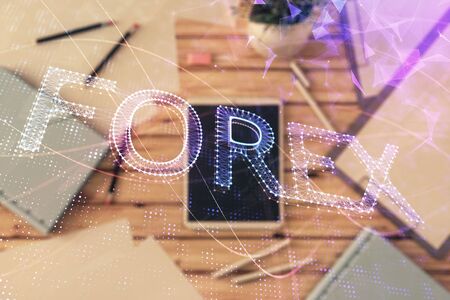 Double exposure of forex graph on digital tablet laying on table background. Concept of market analysisの写真素材